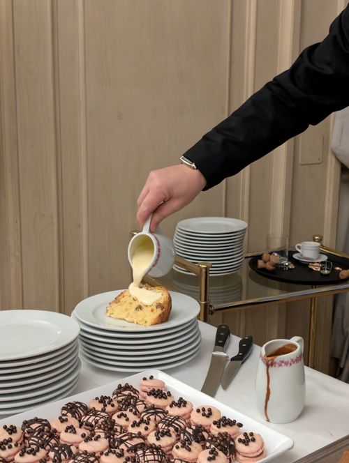 Free Elegant dessert service with custard cake and chocolate-drizzled pastries in Florence. Stock Photo
