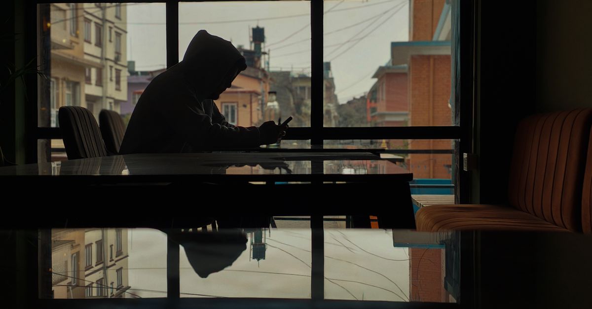 Sunset view from a window with a phone placed face down on a table