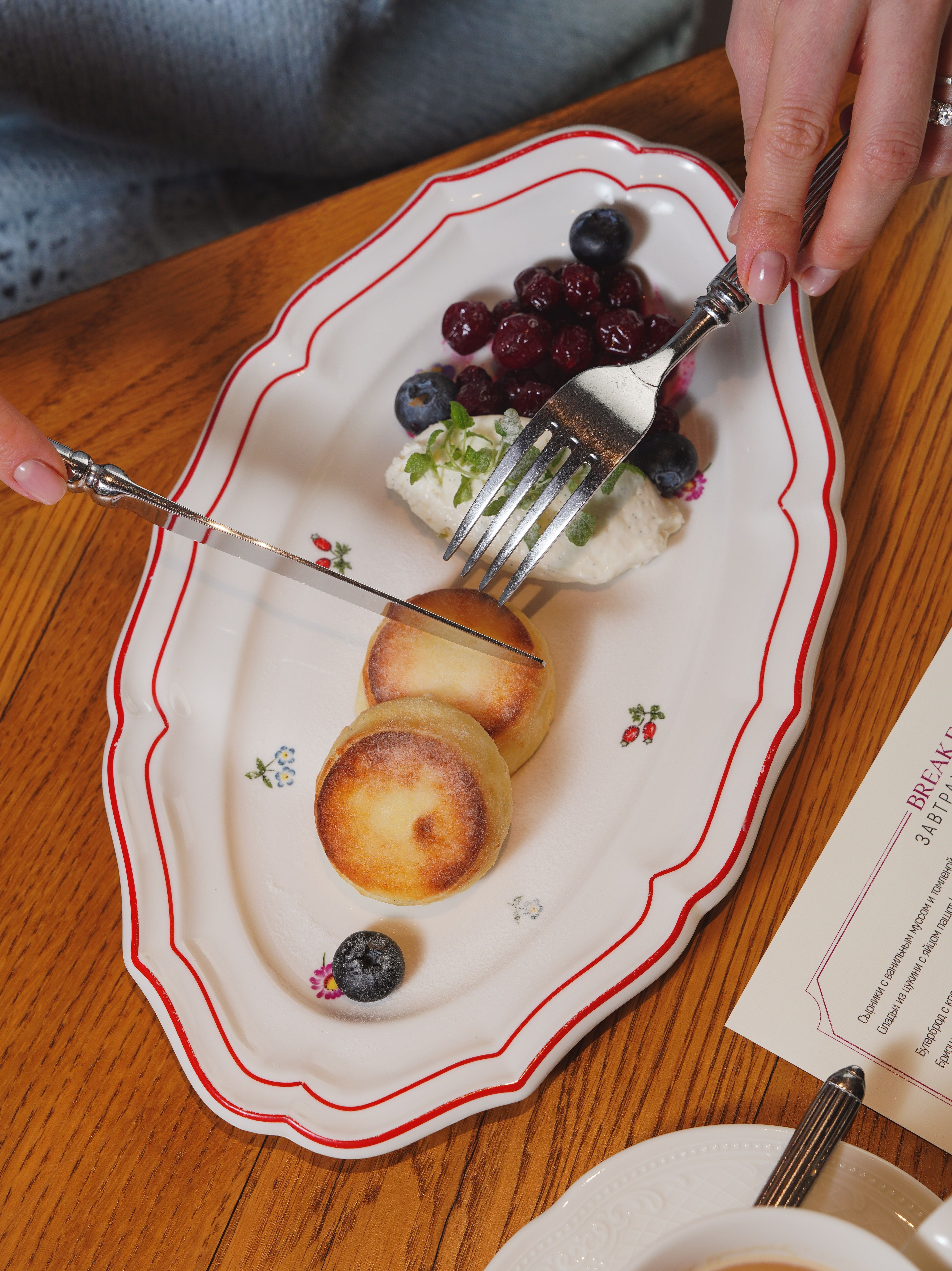 Delicious breakfast pastries with berries on a decorative plate, perfect for a gourmet meal.