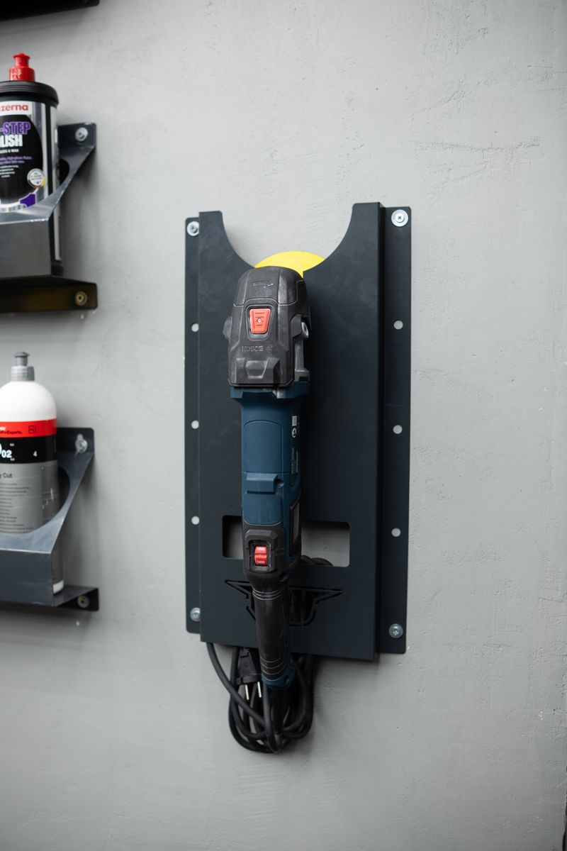 Organized workshop with power tool neatly mounted on a wall bracket.