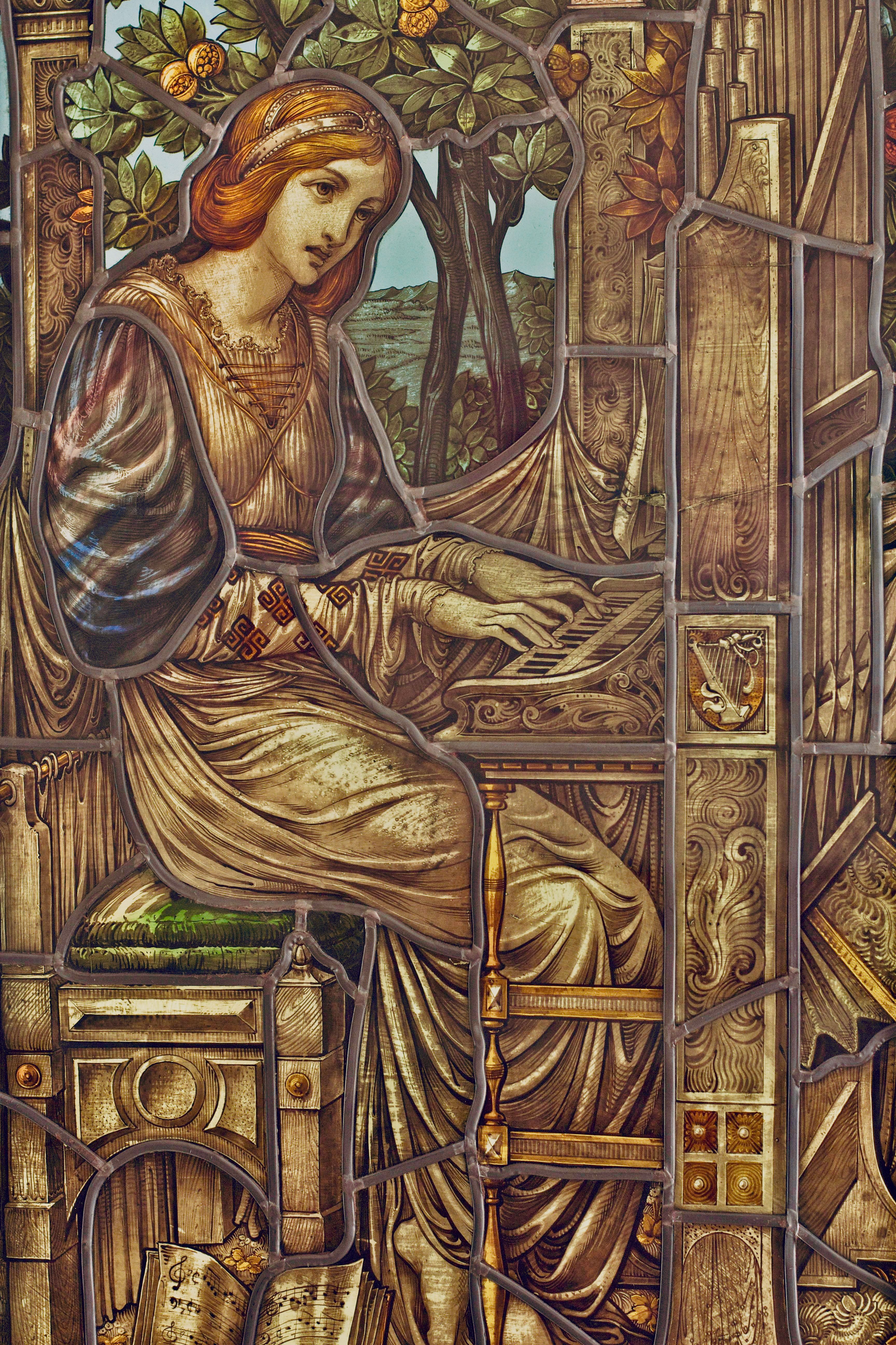 Beautiful stained glass depicting a woman playing an organ, featuring intricate Art Nouveau designs.. pexels, beautiful, stai