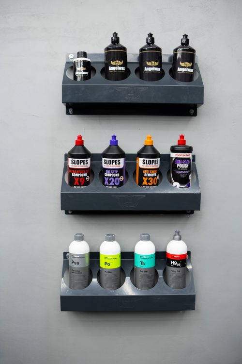 Free Neatly organized shelves with various car cleaning and polishing products in vibrant bottles. Stock Photo