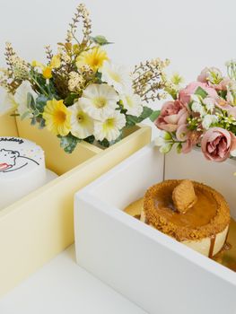 Elegant floral arrangements alongside caramel and birthday cakes.