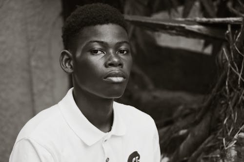 Grayscale Photo of Man in White Polo Shirt