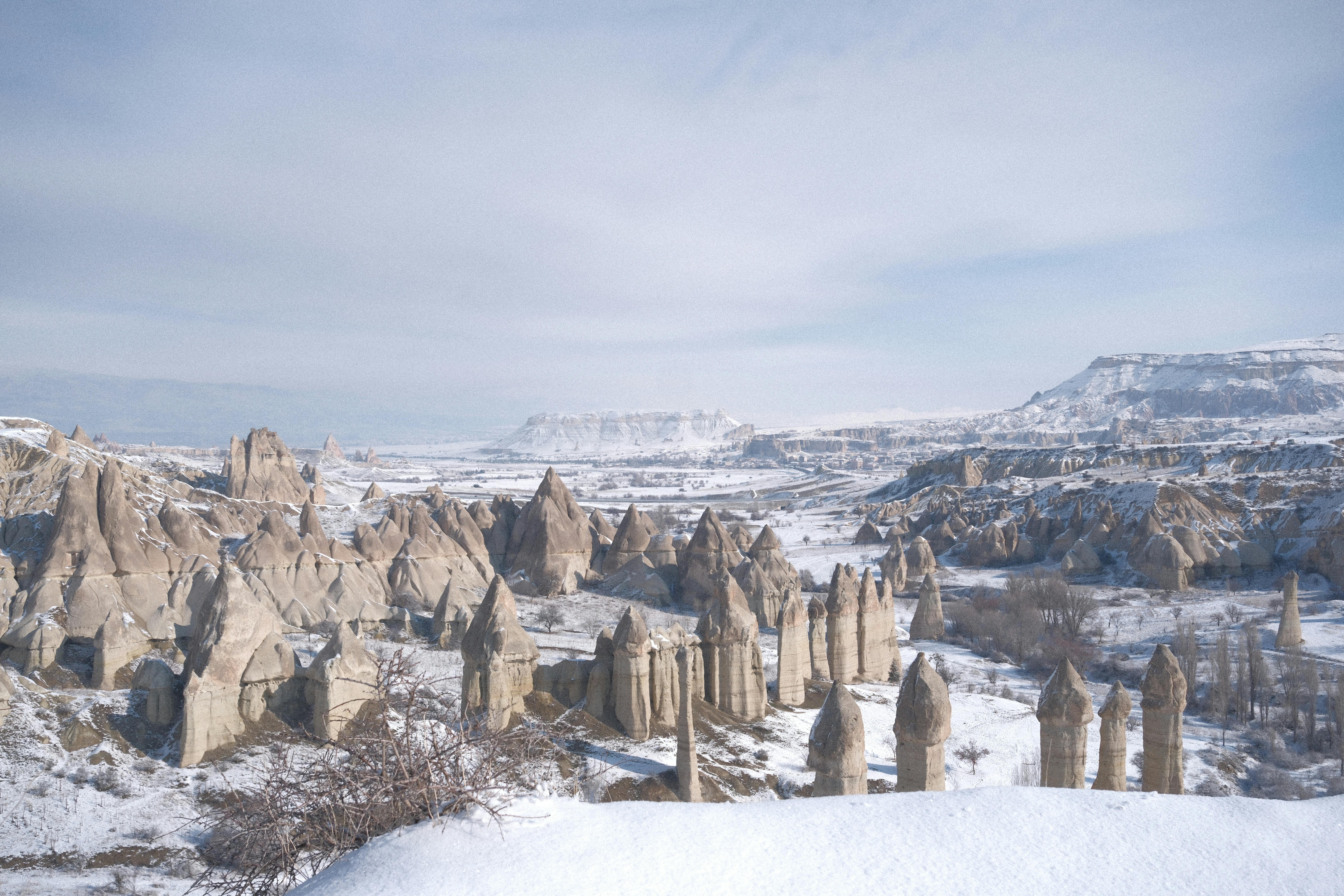 Snow-covered fairy chimneys and valleys in Cappadocia offer a stunning winter landscape.