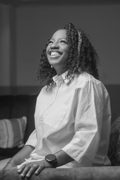Free Black and white portrait capturing the joyful expression of a smiling woman indoors. Stock Photo