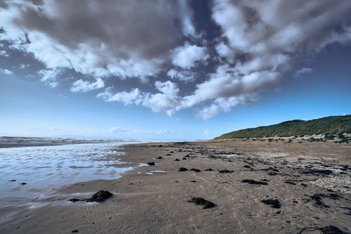Free Serene beach scene at Donegal, Ireland, showcasing coastal dunes and a vivid natural landscape. Stock Photo