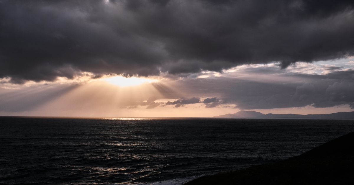 Sun rays break through clouds over Bundoran coast, County Donegal, Ireland.