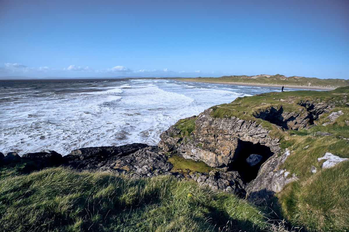 Maghera Beach with sea caves cut into the headland