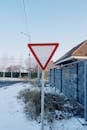 Yield Sign on Snowy Suburban Street