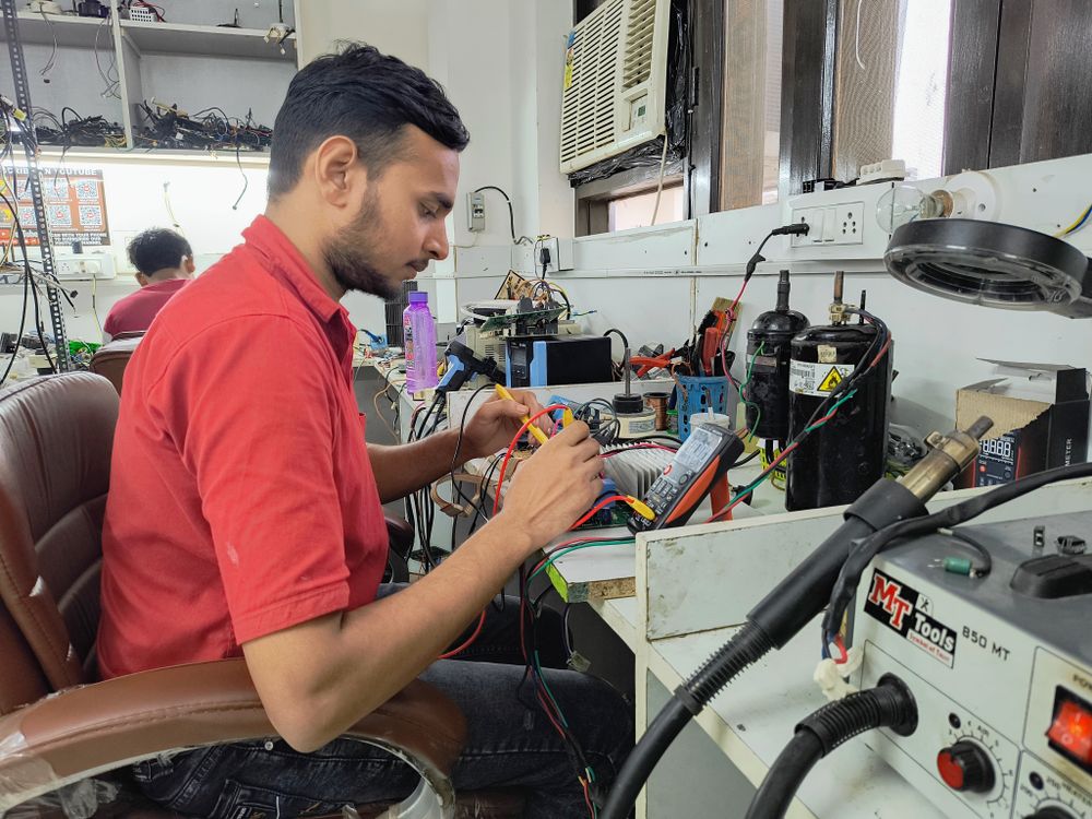 Appliance technician repairing electronic equipment