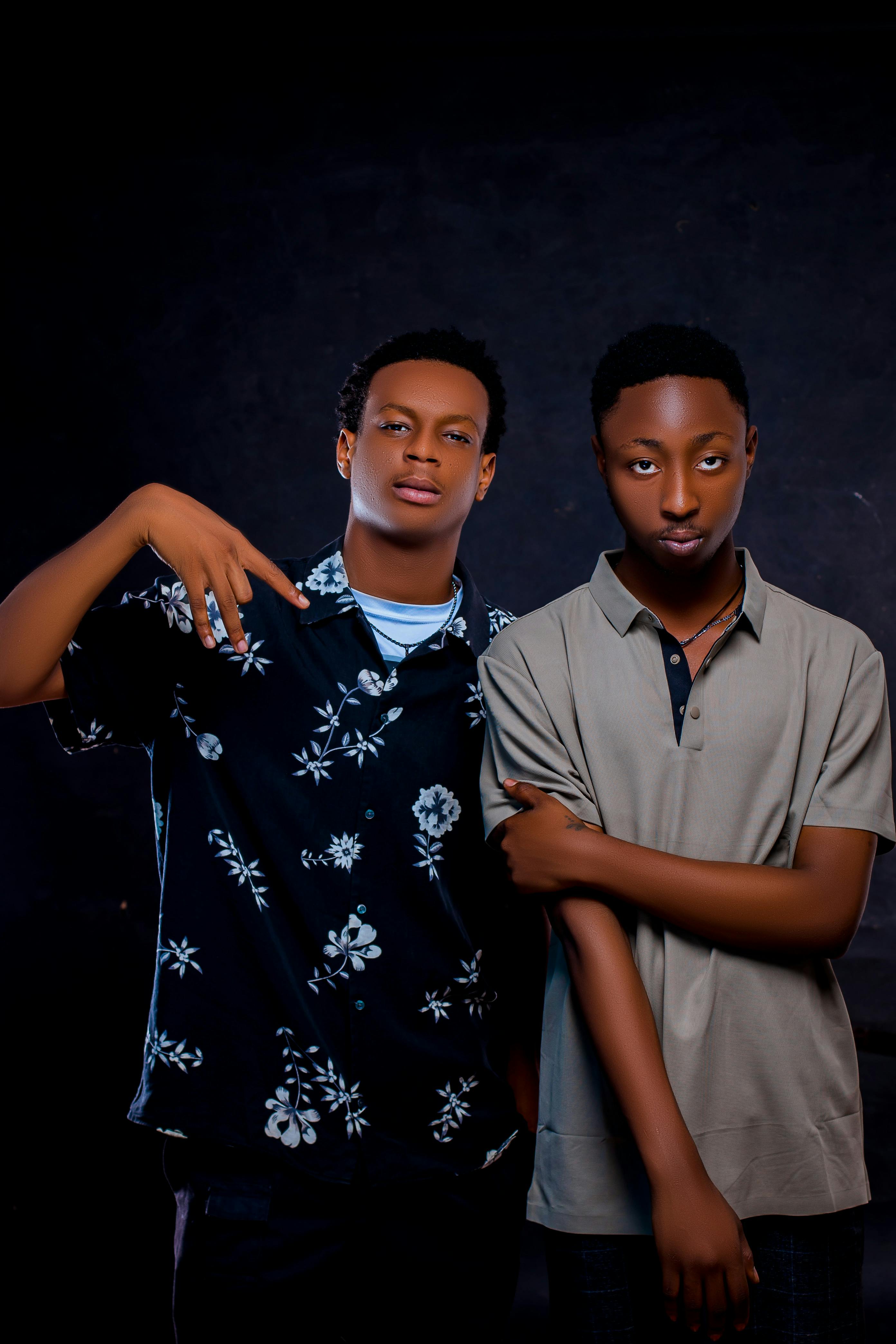 Indoor studio portrait of two young men posing in fashionable casual shirts.