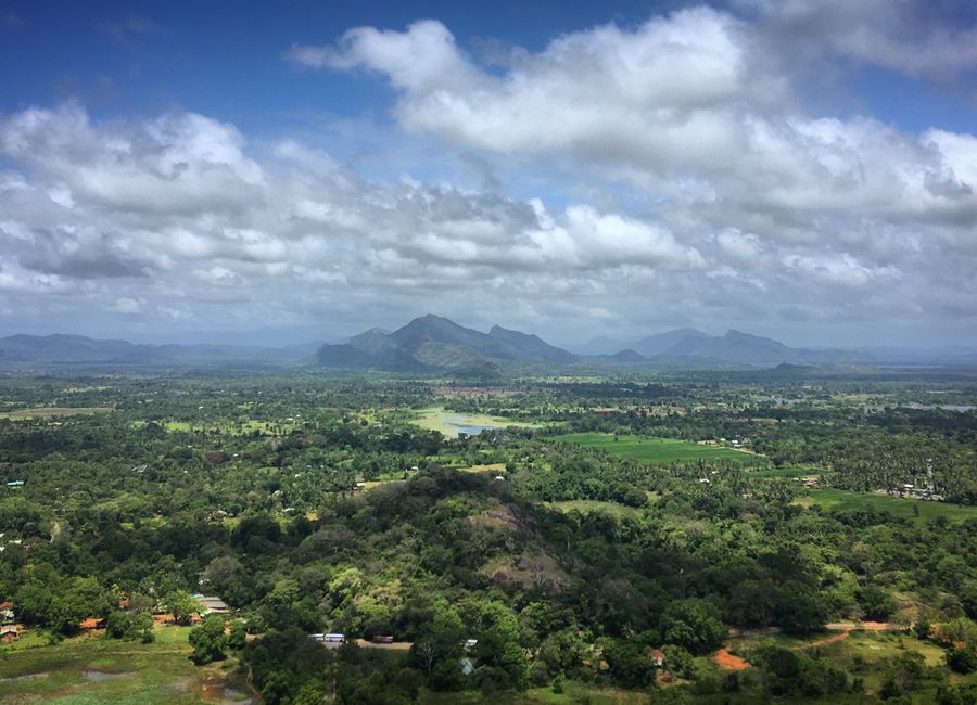 Aerial view of lush landscapes and distant hills in Sri Lanka, capturing natural beauty.