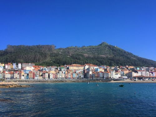Free Scenic coastal view of Caminha, Portugal with colorful buildings and a hillside backdrop. Stock Photo