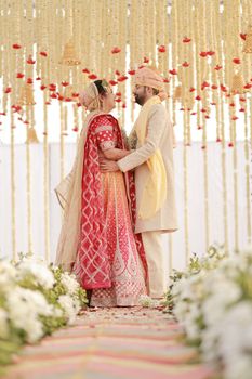 Beautiful portrait of bride and groom in traditional attire during Indian wedding ceremony.