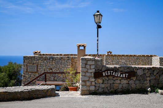A scenic Mediterranean restaurant in the Balearic Islands with stunning stonework and ocean views.