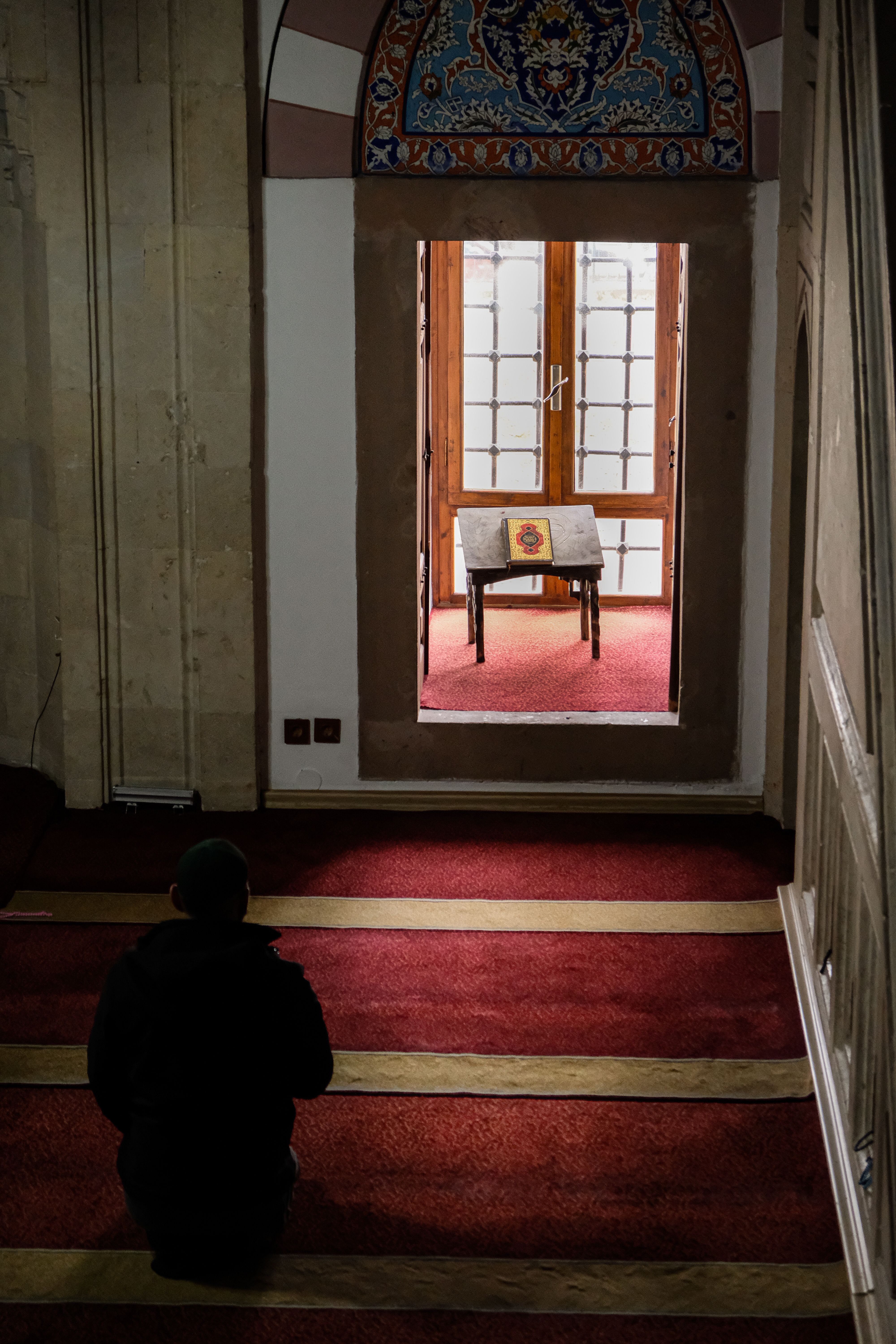 Mosque interior with red prayer carpet