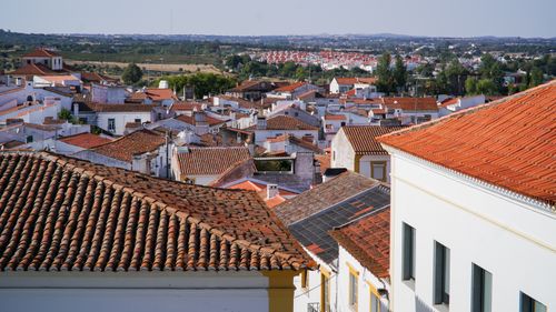 Free A picturesque view of red-tiled rooftops in a charming Spanish village on a sunny day. Stock Photo