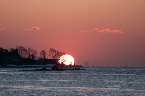Free Beautiful winter sunrise over Stamford Harbor, capturing the tranquil landscape and distant shoreline. Stock Photo
