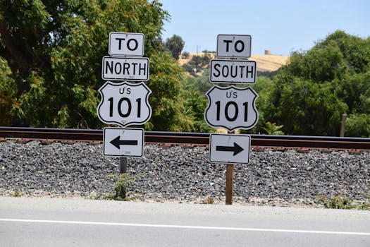 Directional signs for US Route 101 seen in San Miguel, California during a sunny day.