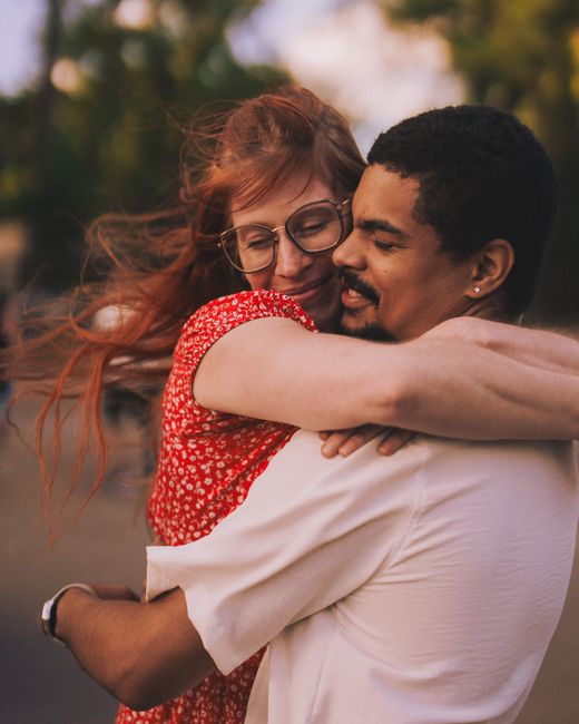 Couple embracing outdoors, expressing affection and warmth.
