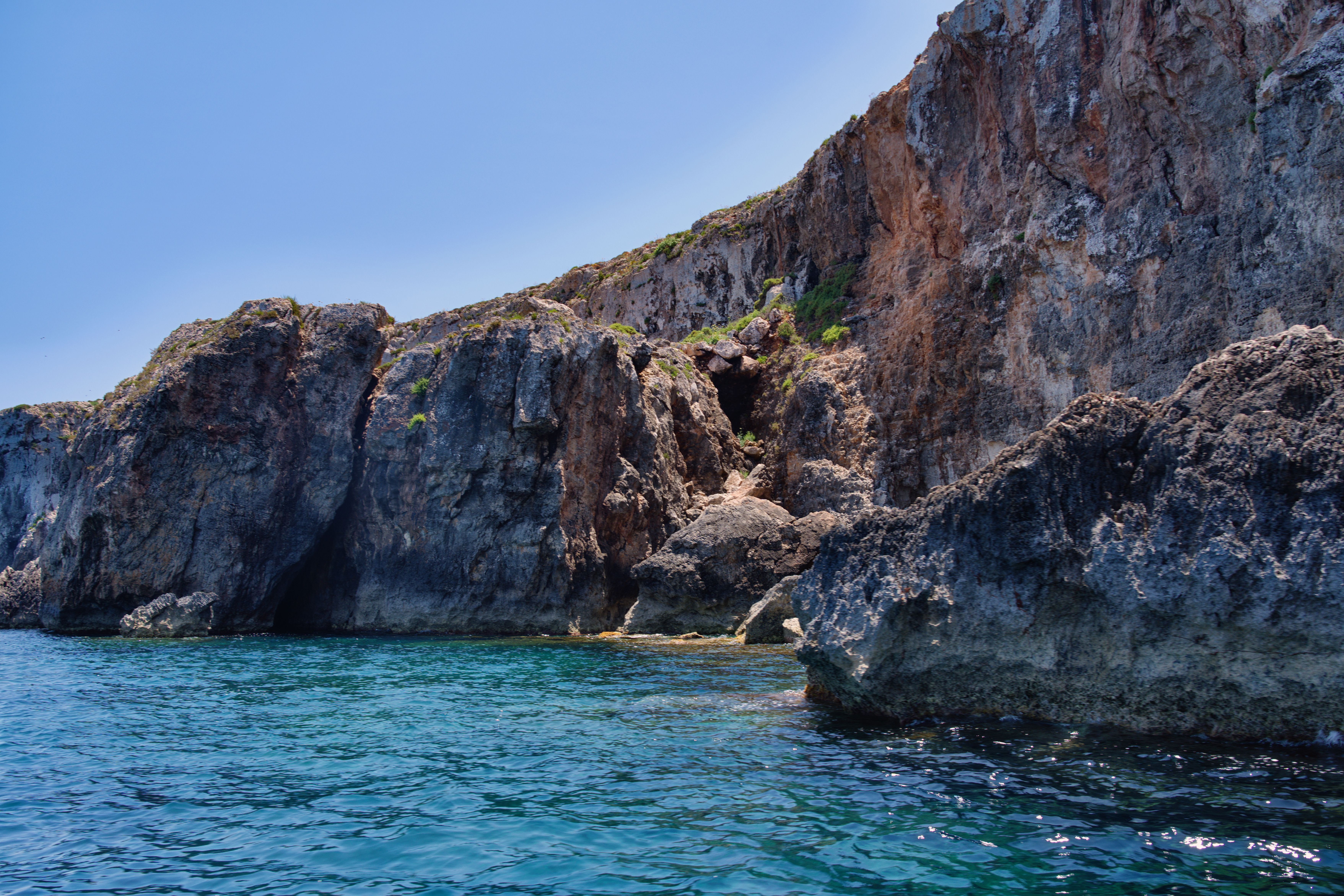 Crystal clear turquoise waters of the Blue Lagoon in Comino, Malta, with tourist boats