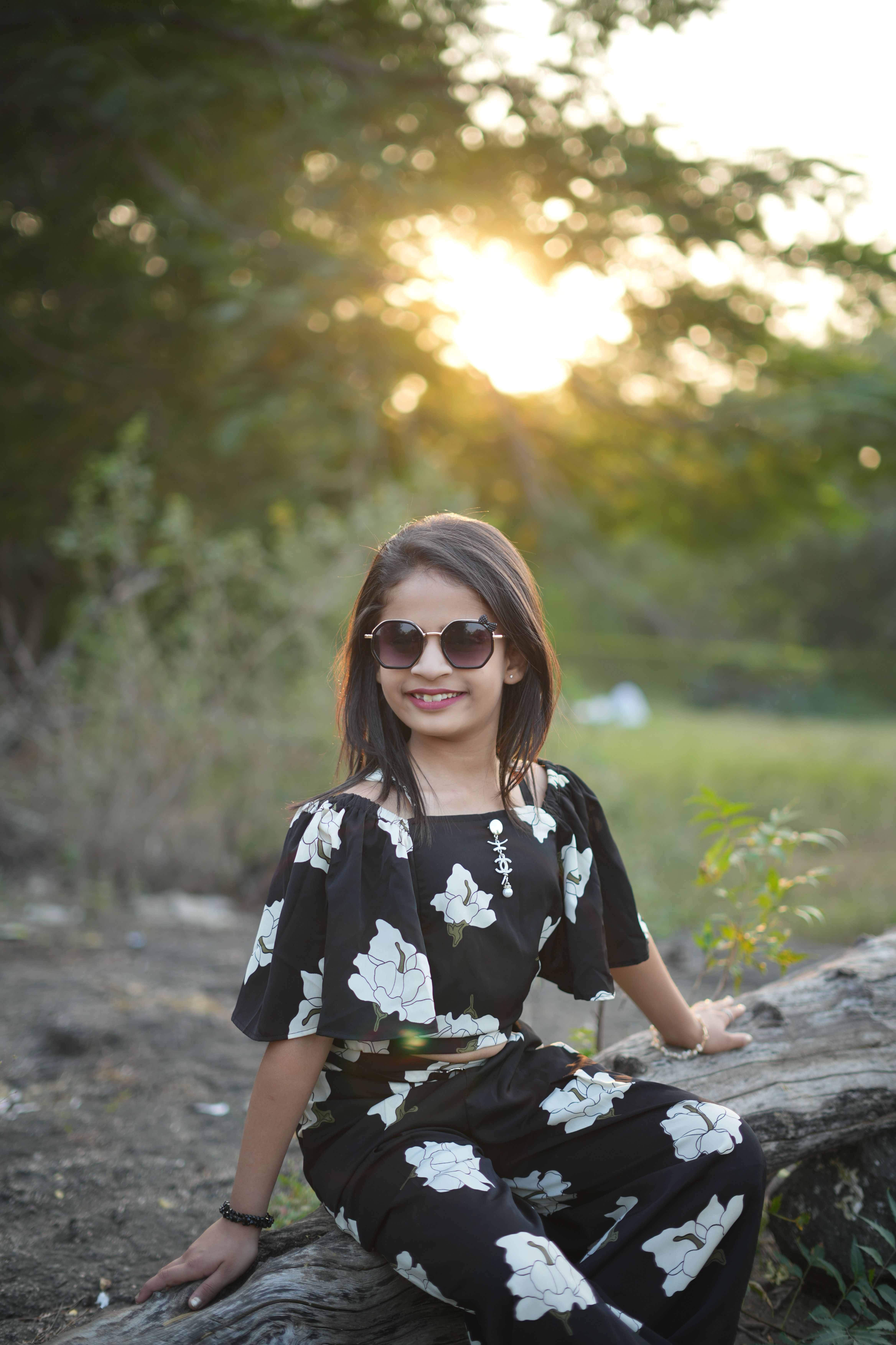 Smiling Girl in Sunglasses at Sunset Outdoors · Free Stock Photo