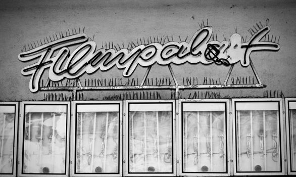 Black and white image featuring an old-fashioned film theater sign.