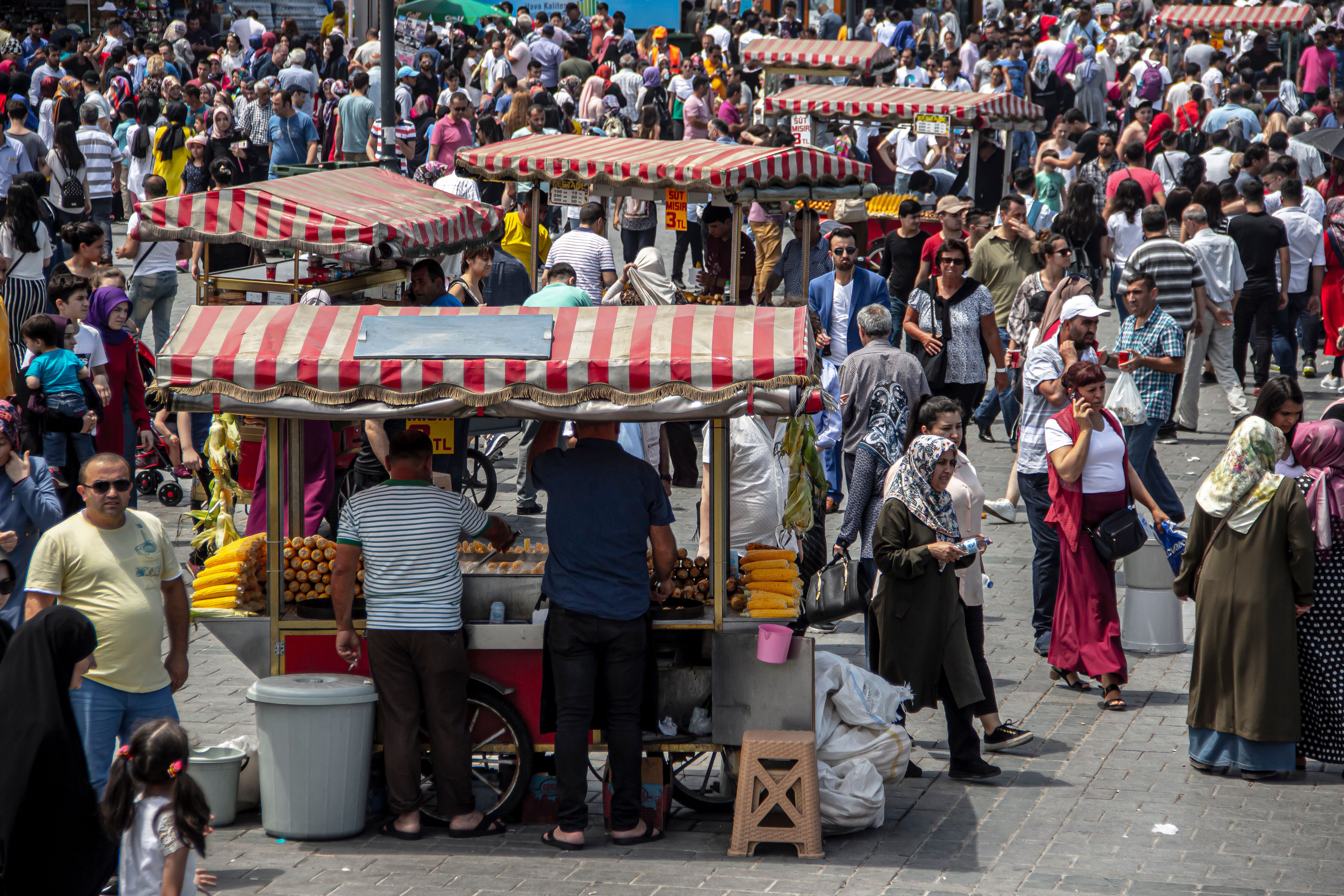 Crowded Istanbul market with street vendors and bustling shoppers.