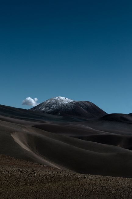 A stunning view of a snow-capped mountain under a clear blue sky.