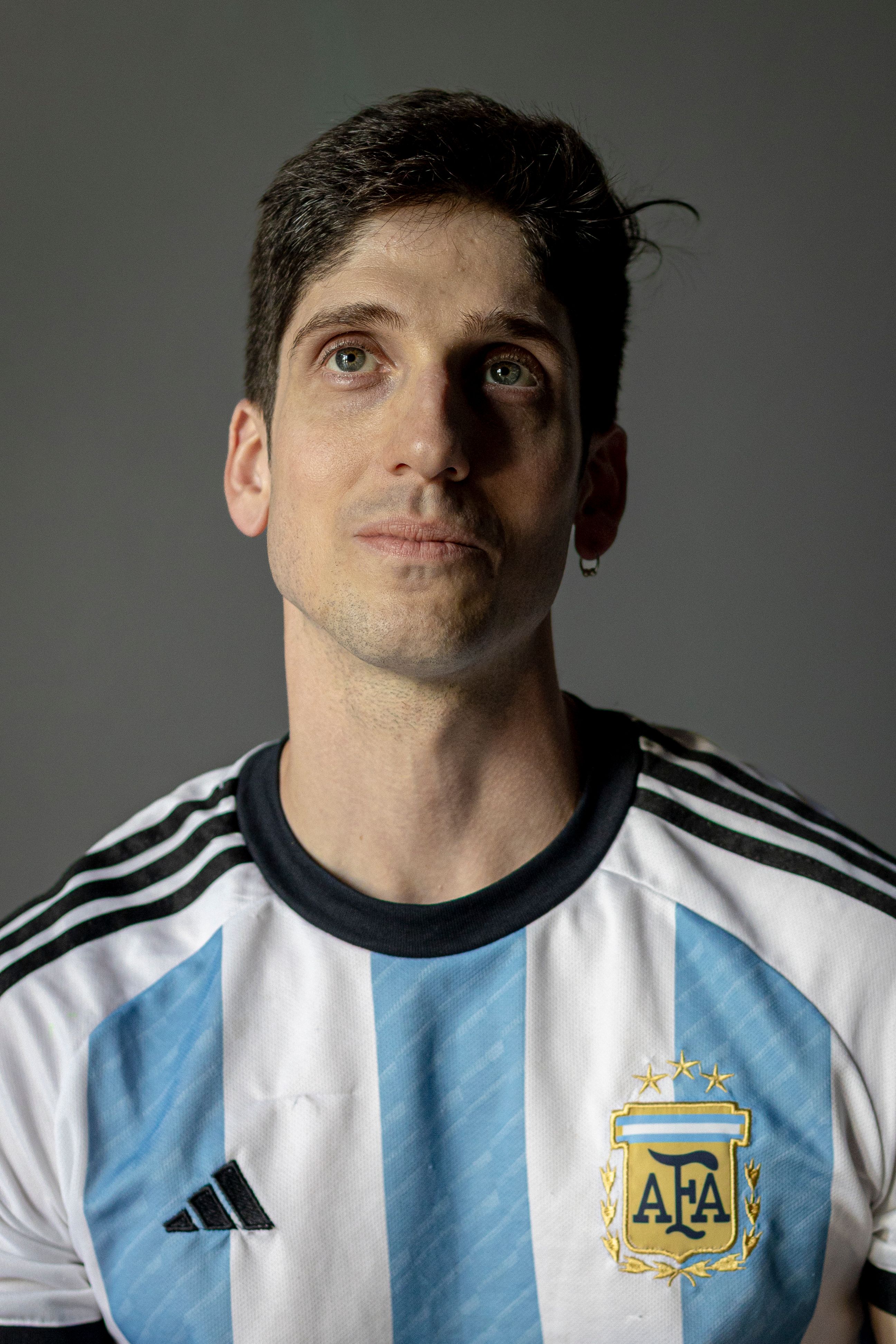 Man wearing an Argentina football jersey, representing national pride.