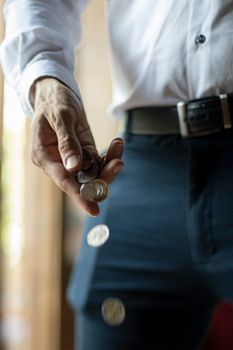 A person dropping coins from their hand emphasizes global finance themes.