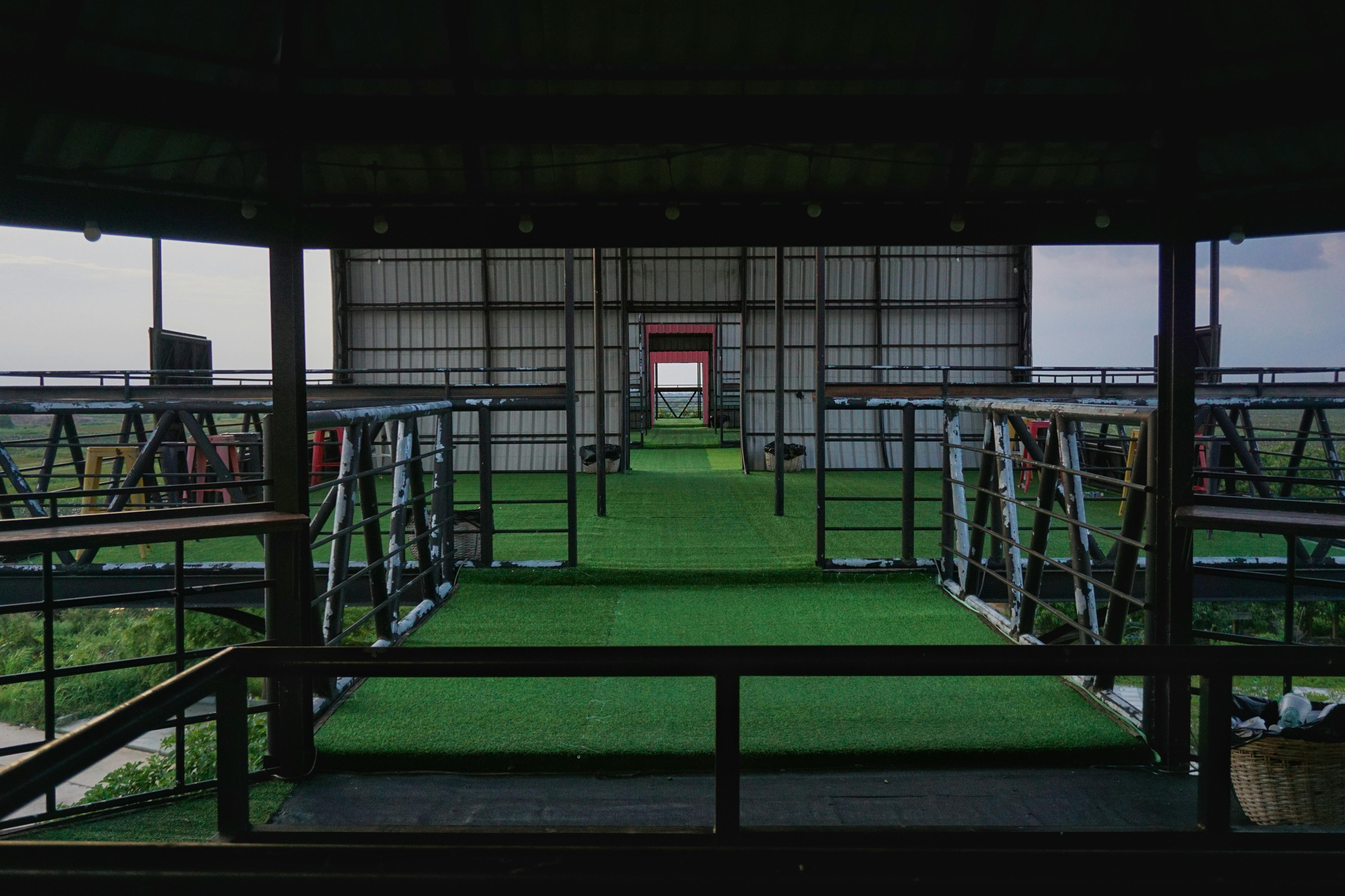 Explore a contemporary outdoor cafe setting with lush green scenery and creative architecture near Phnom Penh. - Phnom Penh