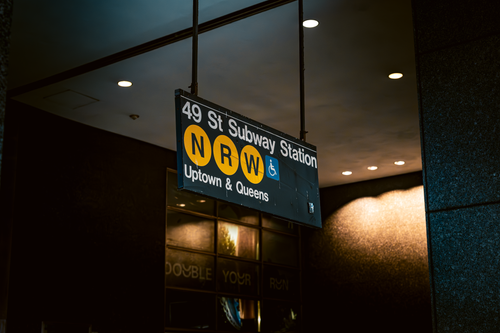 Free NRW subway sign for 49 St in NYC, capturing urban transit in dim lighting. Stock Photo