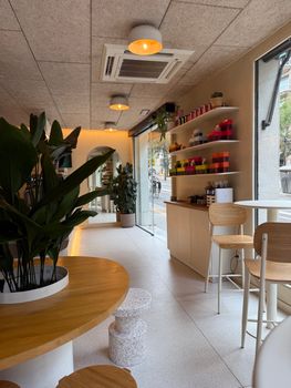 Modern coffee shop in Barcelona with natural lighting and minimalist decor.