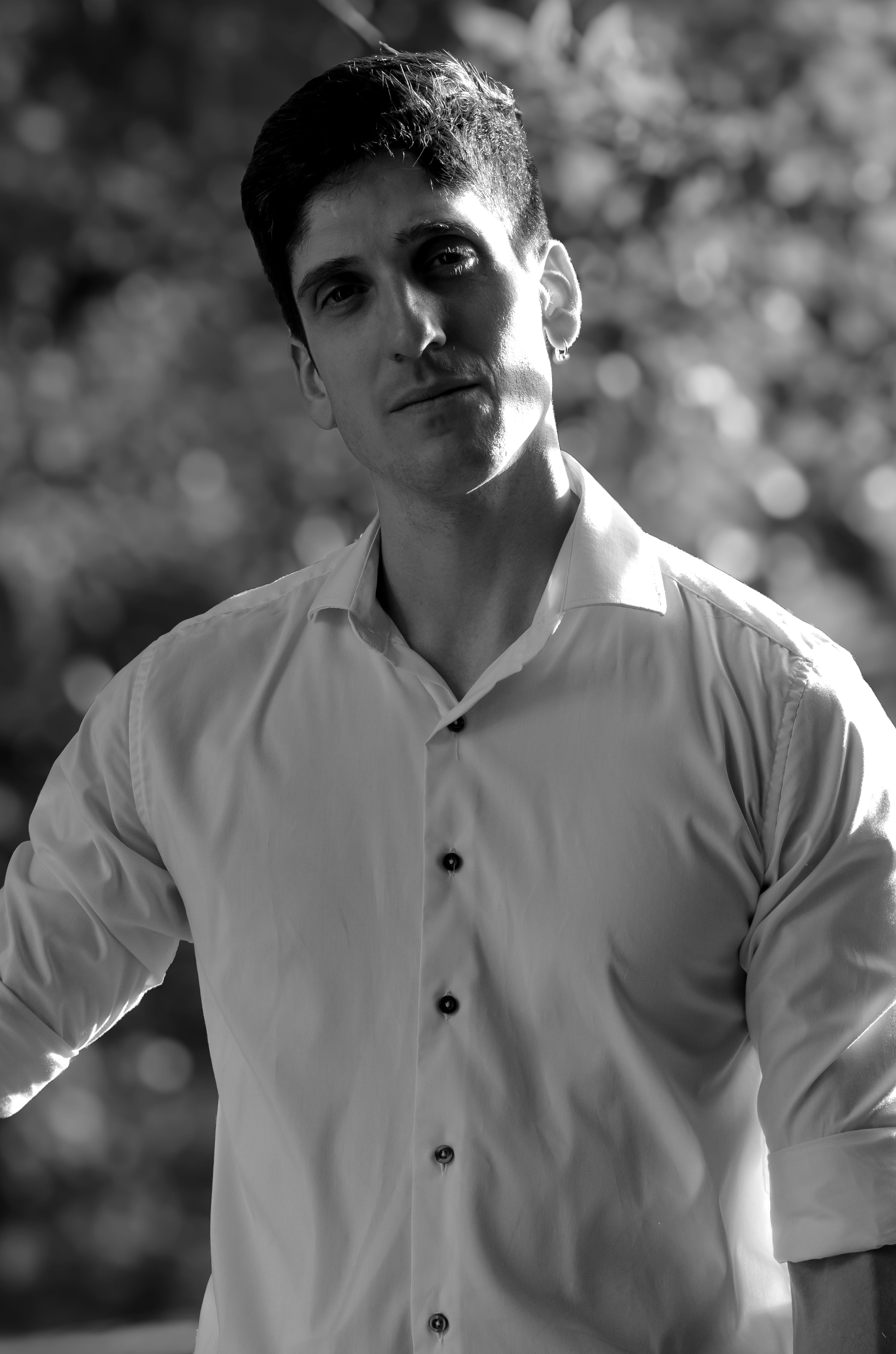 Black and white portrait of a man in a white shirt, captured outdoors in Buenos Aires.