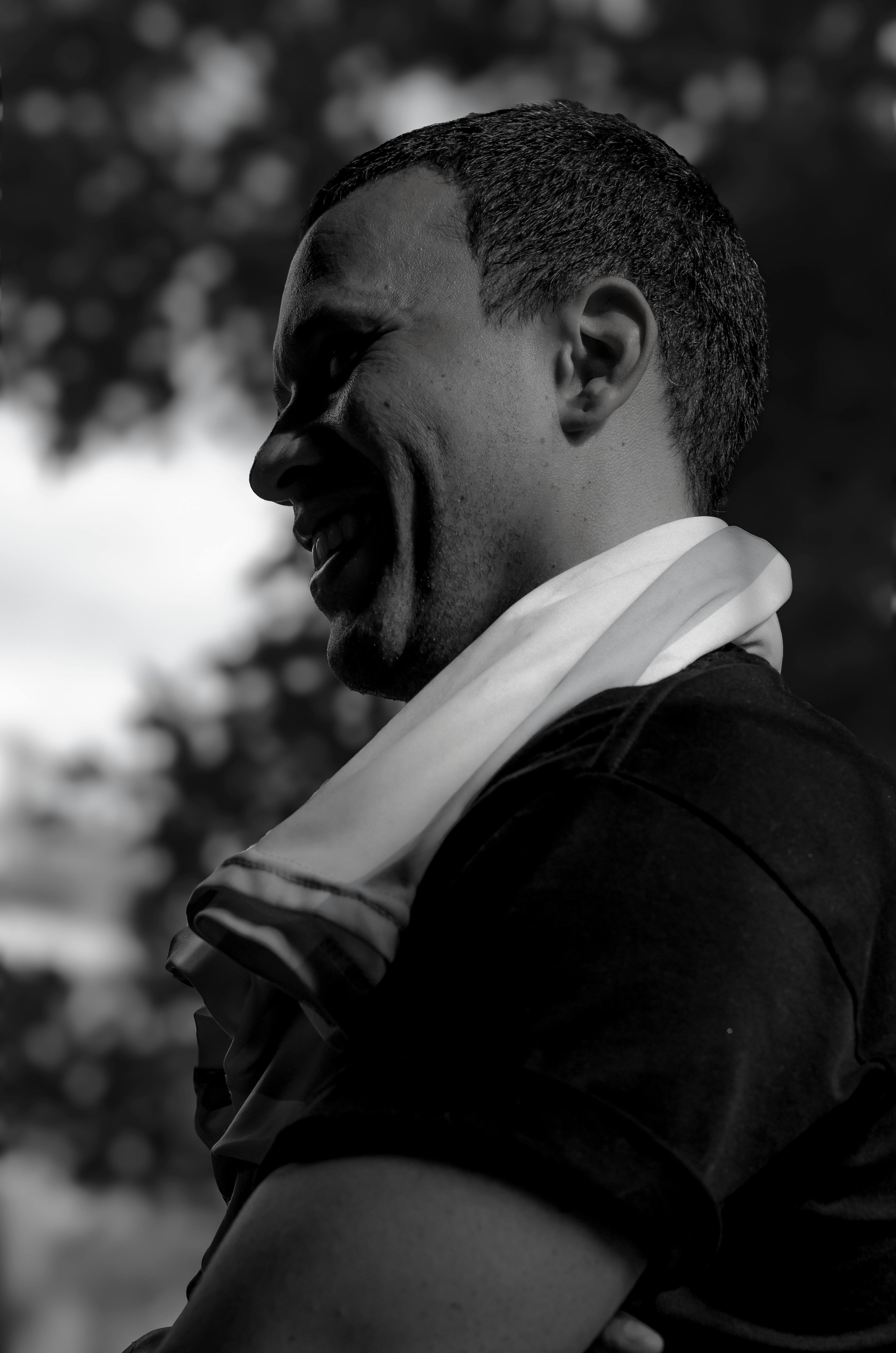 Black and white portrait of a man outdoors in Buenos Aires, highlighting a serene mood.