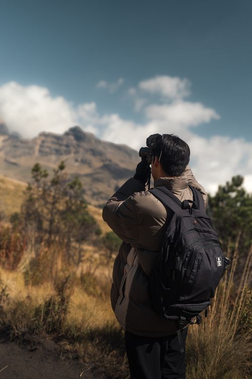 Free A hiker captures the beautiful mountain scenery with a camera, showcasing nature's beauty in Pue., México. Stock Photo