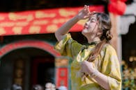 Young Woman Enjoying Sunlight in Traditional Dress