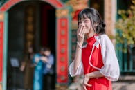 Young Woman in Red Dress Laughing Outdoors