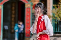Young Woman Laughing in Traditional Red Dress Outdoors