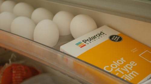 White Eggs Beside Polaroid Film