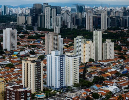 High-angle view of an urban cityscape featuring dense skyscrapers and residential buildings.