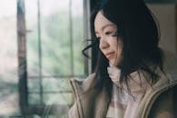 Contemplative Woman Gazing Out of Window