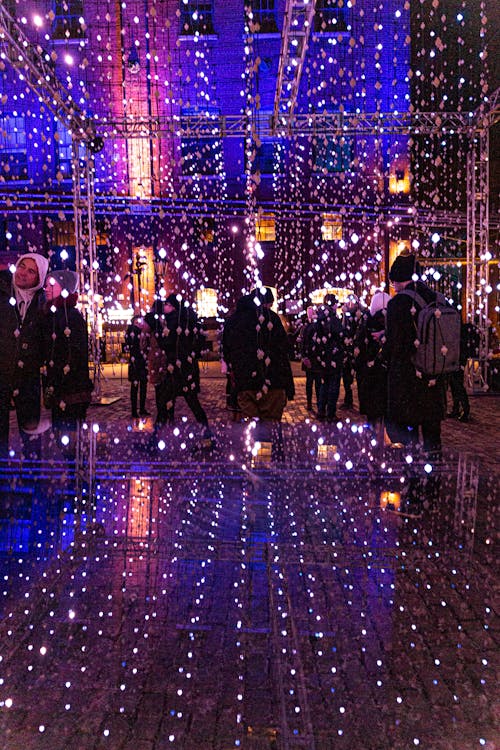 People Walking on Lighted Hallway