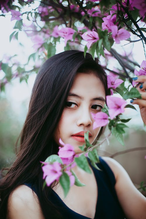 Photo Of Woman Beside Pink Flowers