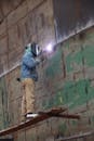 Industrial Welder Working on Large Metal Construction