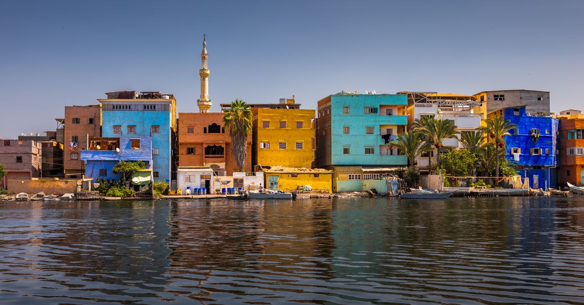 Vibrant Riverside Colorful Riverside Buildings in Vibrant Town · Free Stock Photo
