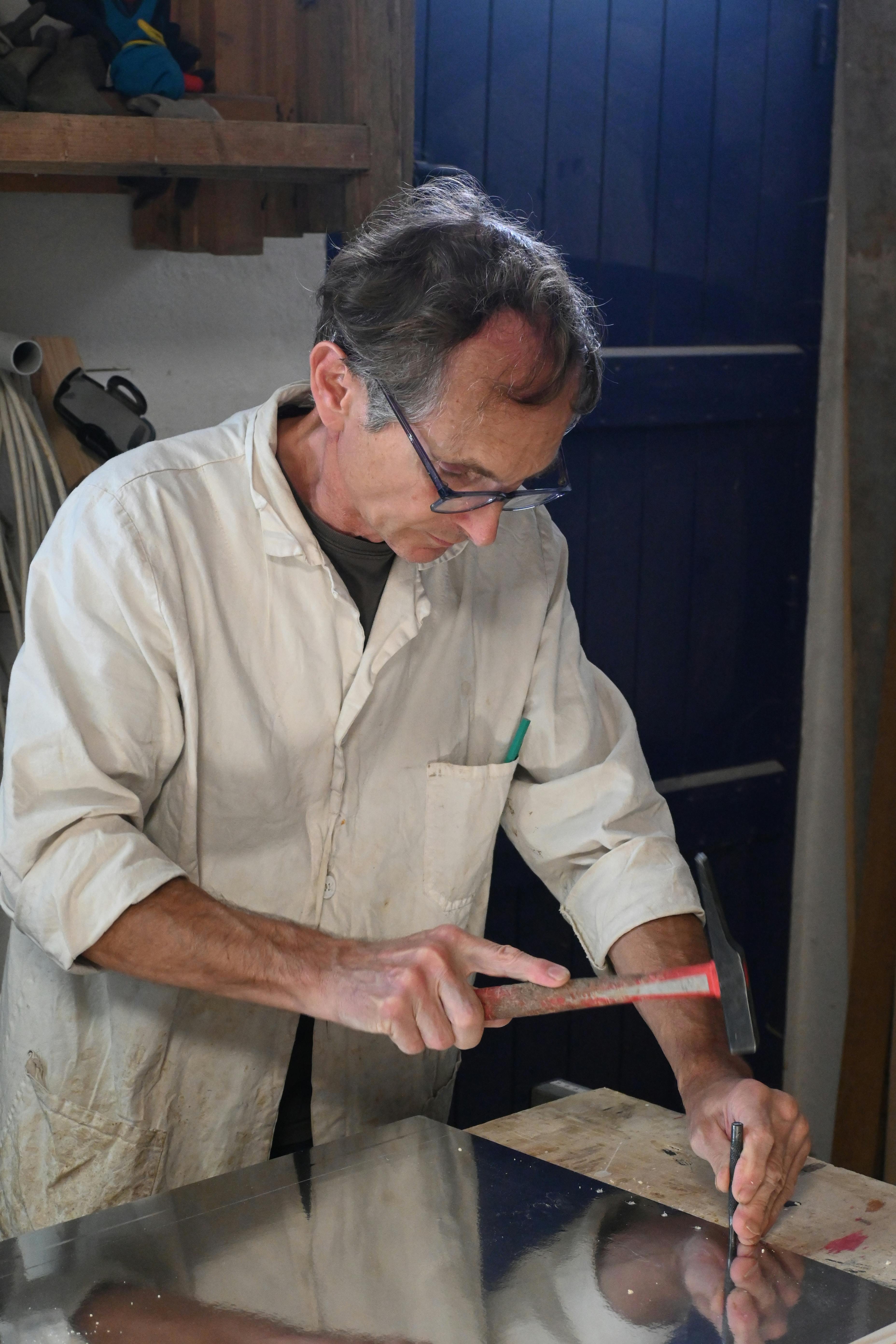 Experienced artisan focused on woodworking in a traditional workshop.