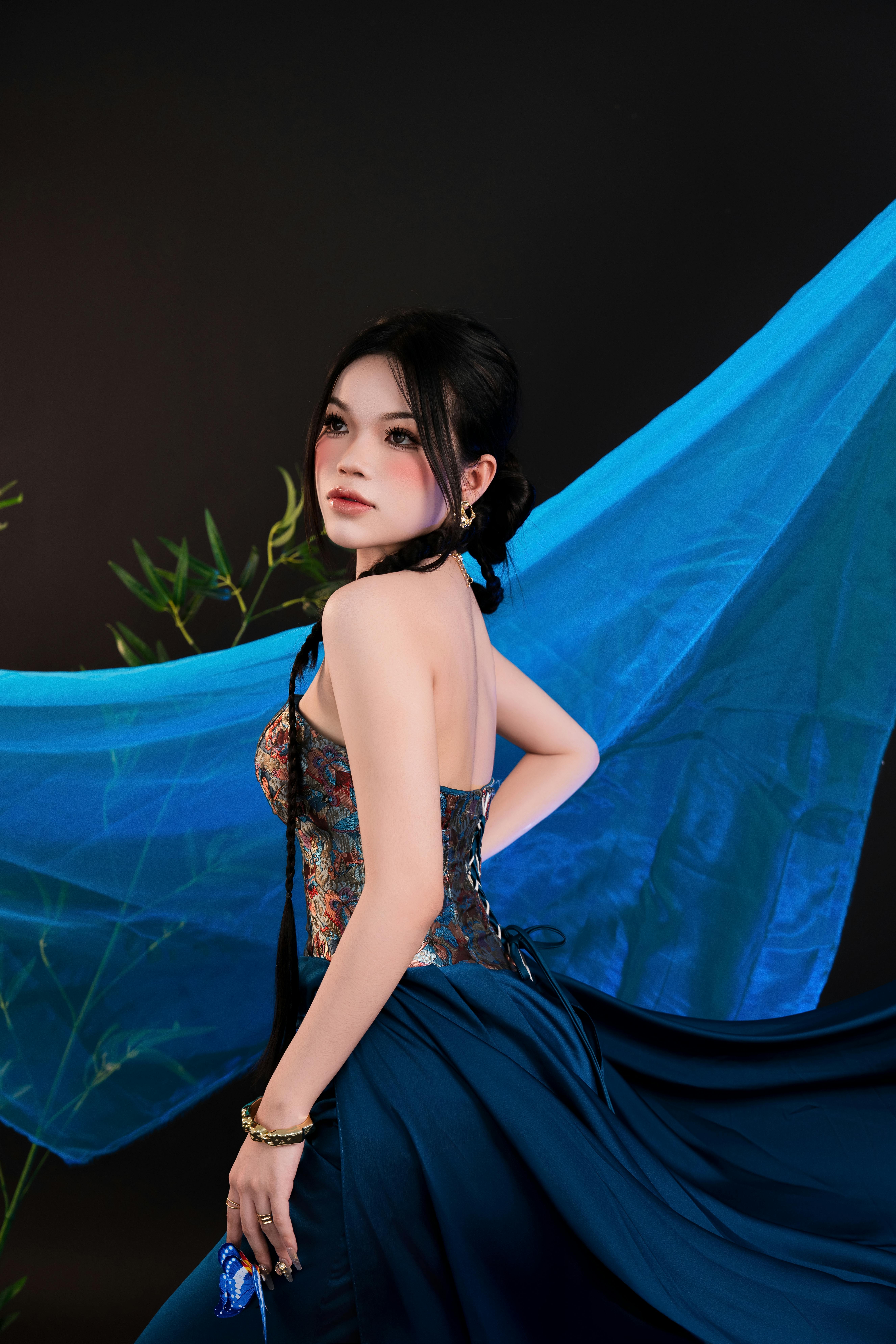 Elegant Woman in Blue Dress with Flowing Fabric